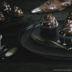 Whisky Cupcakes auf Teller mit Spritztülle im Hintergrund
