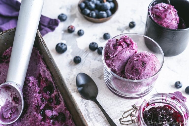 veganes Kokos Heildelbeereis 2 | Kaum etwas gehört für uns so sehr zum Sommer wie selbst gemachtes Eis – aber ehrlich gesagt löffeln wir es das ganze Jahr. Über die Jahre ist eine bunte Sammlung entstanden: cremiges Milcheis aus der Eismaschine, fruchtige Sorbets, leichtes Joghurteis und richtig angeberische Eisdesserts.