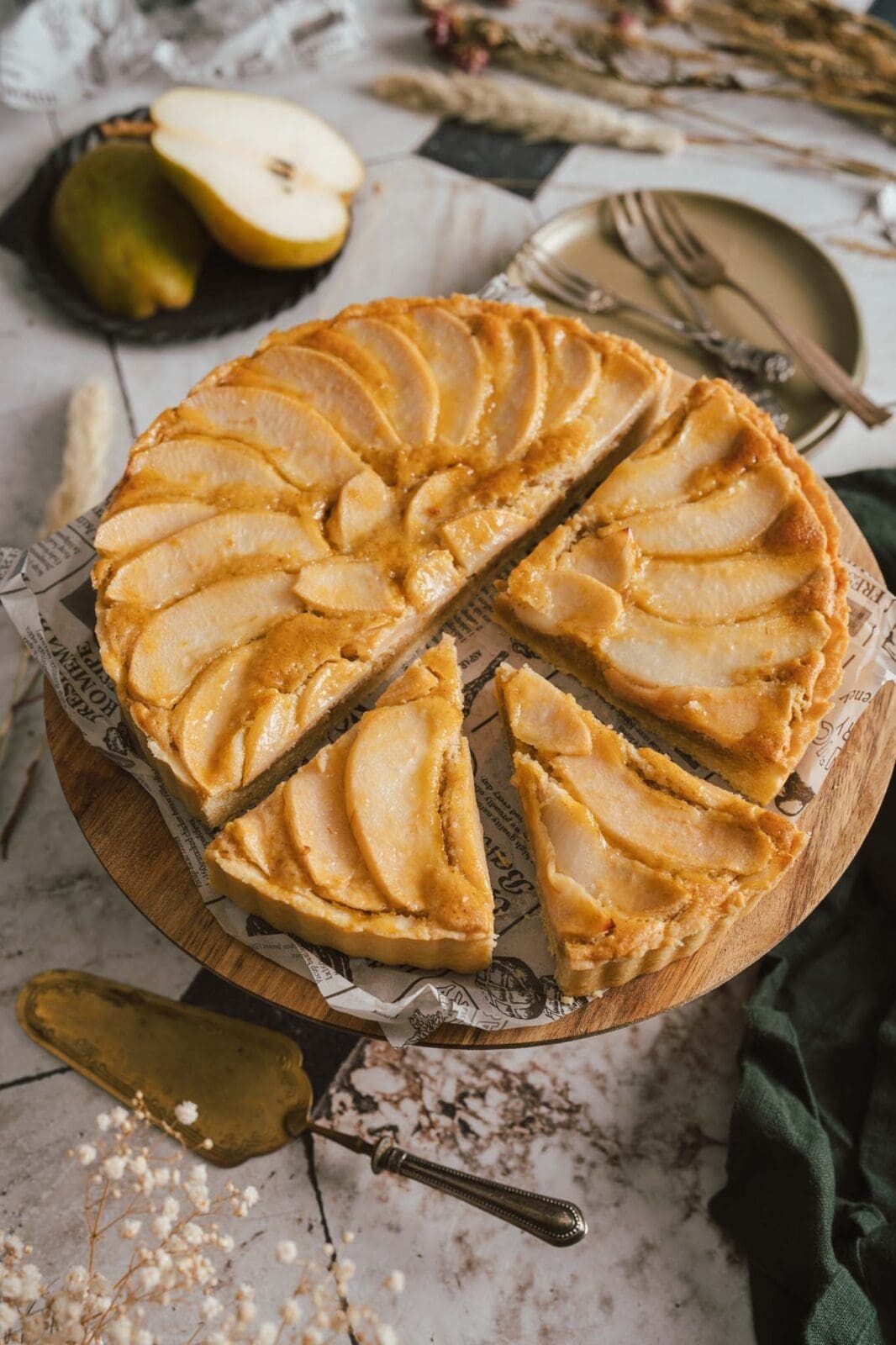 Birnen Haselnuss Tarte 2 | Wir geben es zu: Gebackene Birnen stehen bei uns nicht ganz oben auf der Favoritenliste. Aber zum Glück haben wir im vergangenen Jahr eine Birnen-Haselnuss-Tarte in einer Konditorei ausprobiert – und waren sofort hin und weg! Die Kombination aus süßen, saftigen Birnen, knusprigem Mürbeteig und nussiger Haselnuss-Frangipane hat uns so begeistert, dass wir unser eigenes Rezept entwickelt haben. Und was sollen wir sagen? Diese Birnen-Haselnuss-Tarte ist einfach genau das Richtige für die Kaffeetafel am Sonntag! Oder auch einfach nur so zwischendurch. Wenn ihr also Lust auf eine Tarte habt, die perfekt abgestimmt ist, dann probiert unsere Birnen-Haselnuss-Tarte unbedingt aus.